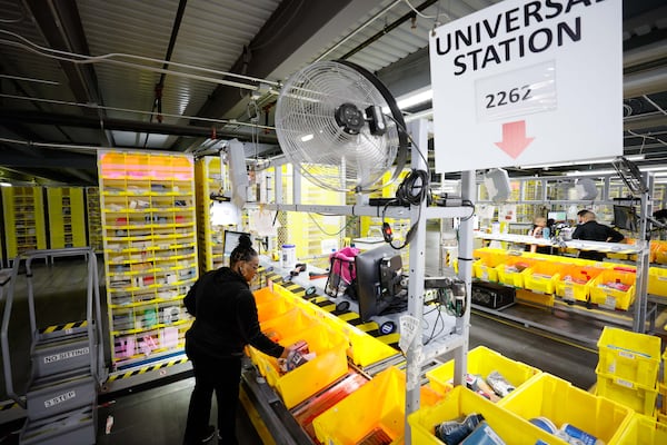 An Amazon employee is seen handling packages at the Universal Station, organized by size and ready to be in the inventory section on Monday, December 2, 2024, during one of the company’s busiest days. The Amazon distribution center in Stone Mountain fulfills hundreds of thousands of orders during Cyber Monday.
(Miguel Martinez / AJC)