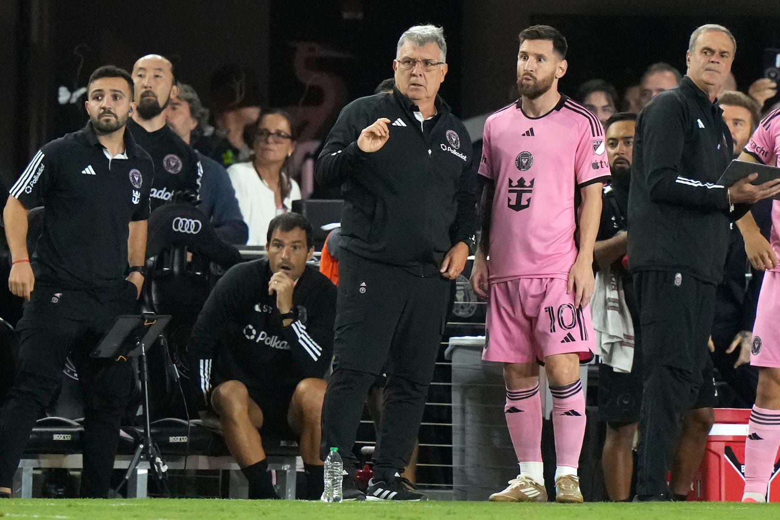 Inter Miami forward Lionel Messi (10) talks with head coach Gerardo "Tata" Martino during the second half of an MLS soccer match against the New England Revolution, Saturday, Oct. 19, 2024, in Fort Lauderdale, Fla. (AP Photo/Lynne Sladky)