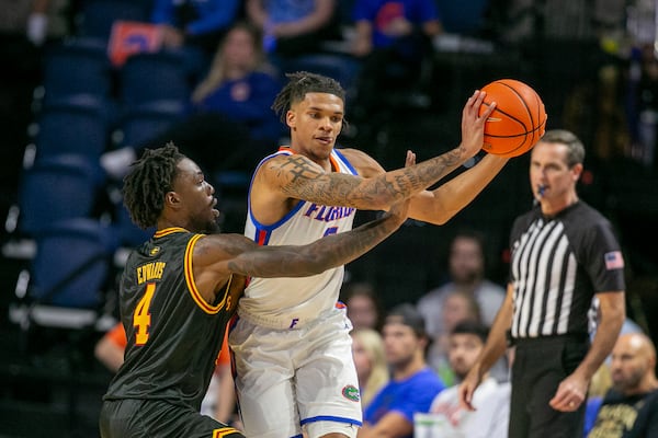 Grambling State guard P.J. Edwards (4) pressures Florida guard Will Richard, right, during the first half of an NCAA college basketball game, Monday, Nov. 11, 2024, in Gainesville, Fla. (AP Photo/Alan Youngblood)