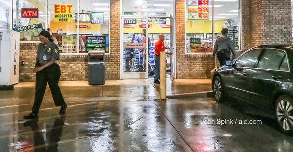 South Fulton police investigate an early Wednesday morning shooting at a gas station on Spence Road. Several shell casings were found scattered around the parking lot. JOHN SPINK / JSPINK@AJC.COM