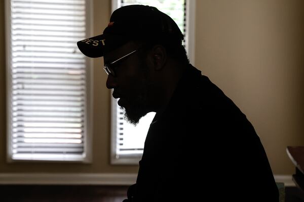 Thomas Lecky sits in the living room in his Decatur apartment on Wednesday, May 31, 2023. (Natrice Miller/natrice.miller@ajc.com)