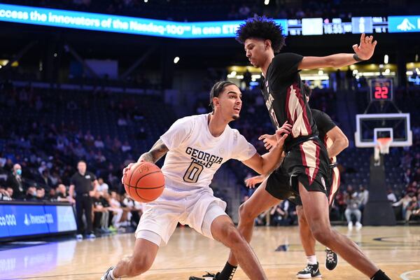 Georgia Tech guard Michael Devoe dribbles against Florida State forward John Butler in the Yellow Jackets' 75-61 win over the Seminoles Jan. 26, 2022 at McCamish Pavilion. (Danny Karnik/Georgia Tech Athletics)