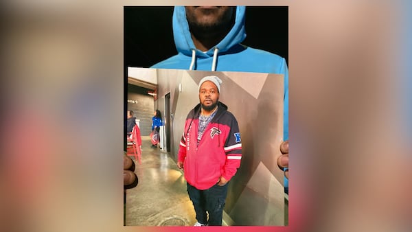 Terence Guthrie holds a photo of his stepfather, Ryan Hines, who was killed in a crash while driving his Polaris Slingshot, a three-wheeled motorcycle.