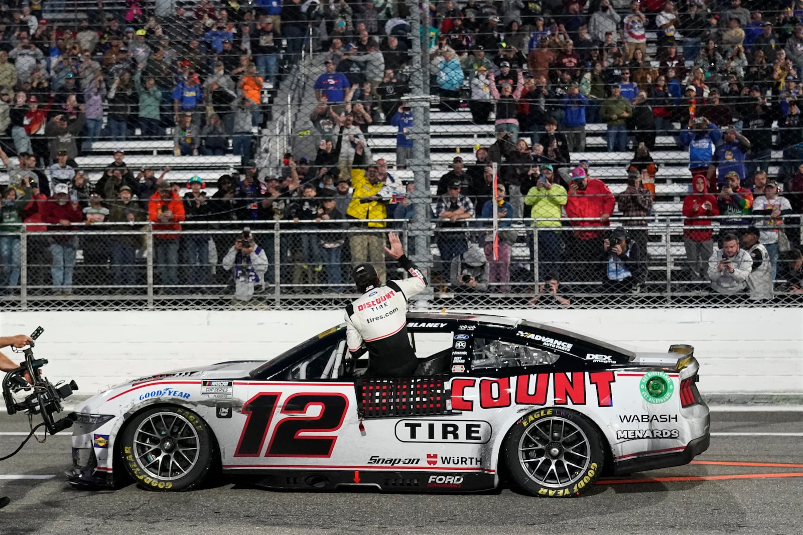 Ryan Blaney, cener, celebrates after winning a NASCAR Cup Series auto race at Martinsville Speedway in Martinsville, Va., Sunday, Nov. 3, 2024. (AP Photo/Chuck Burton)