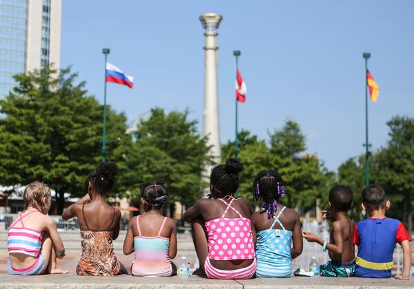 A group of children in the Bright Horizons summer camp program sit beside the Fountain of Rings in Centennial Olympic Park in 2016. Centennial Olympic Park was home to the games in 1996, and is now open to the public for music concerts and a famous firework show on the Fourth of July. The park is surrounded by several Atlanta landmarks such as the CNN Center and the College Football Hall of Fame.    EMILY JENKINS/ EJENKINS@AJC.COM