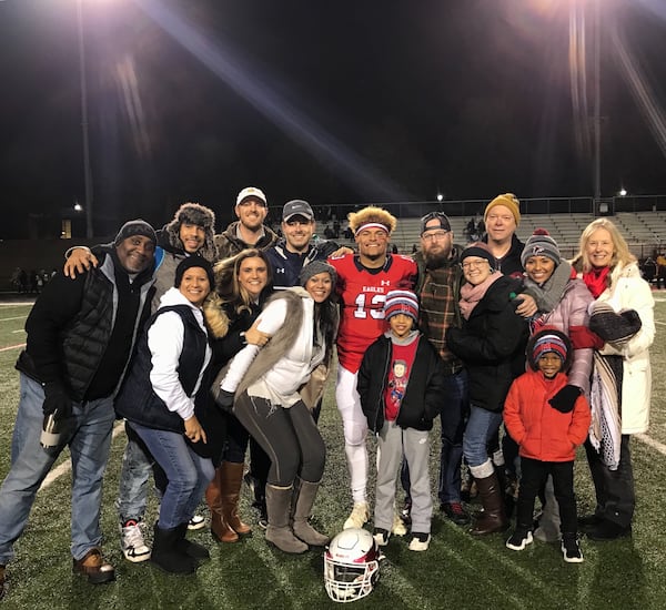 Georgia Tech freshman quarterback Jordan Yates with his family after a game last season at Milton High. In the photo are Jordan's father Evan Yates (to Jordan's immediate right in the Nike cap), stepmother Ashley Yates (white jacket in front of Evan), mother Camille Grayson (in Falcons' winter cap) and stepfather Ray Grayson (in the fur-lined cap on the far left). (Courtesy Evan Yates)