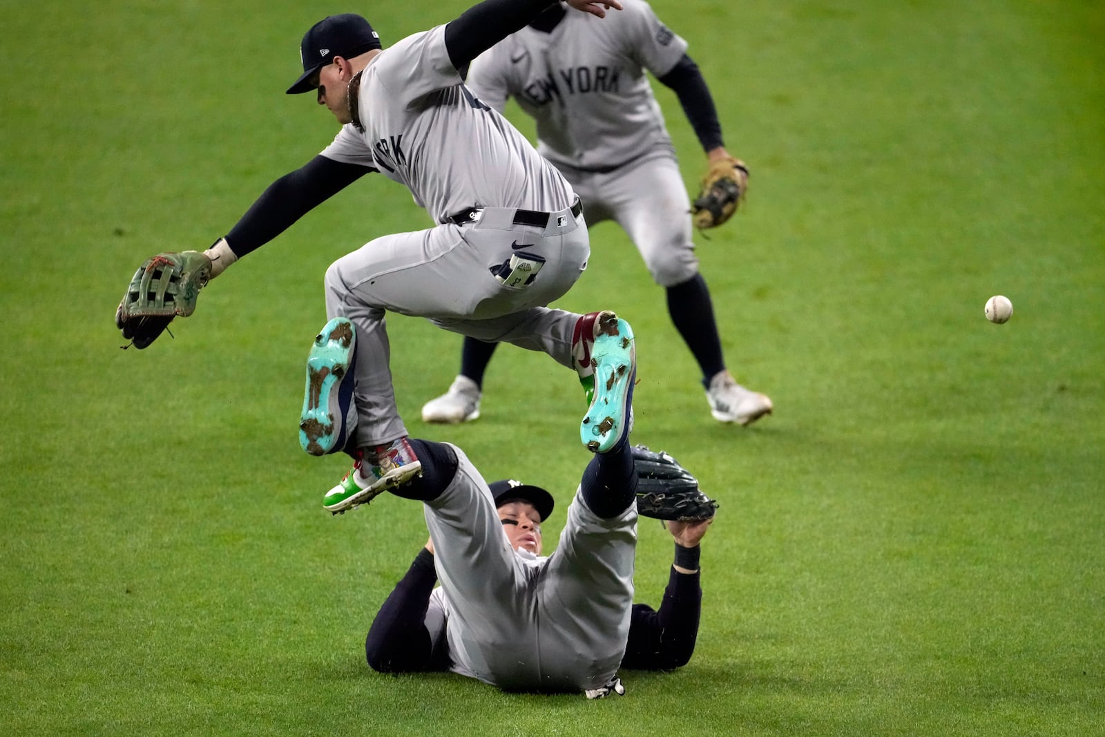 New York Yankees left fielder Alex Verdugo, top, leaps over center fielder Aaron Judge as Judge tries to catch a fly ball by Cleveland Guardians' David Fry during the fifth inning in Game 5 of the baseball AL Championship Series Saturday, Oct. 19, 2024, in Cleveland. (AP Photo/Jeff Roberson)