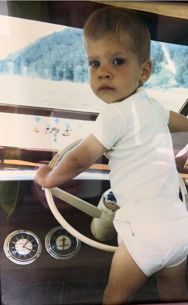 David Cowan pretends to steer his father’s boat as a child in the 1960s. 