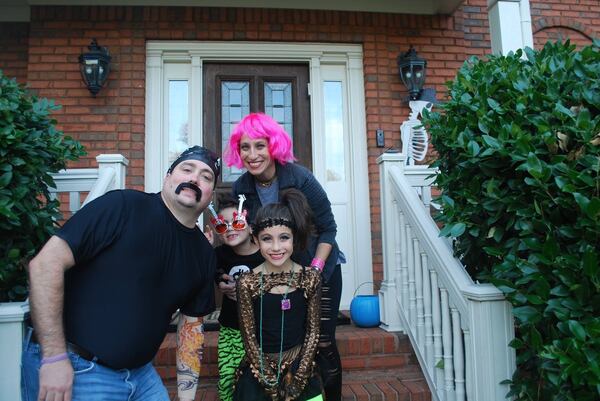 Emily Moore (pictured with pink hair) enjoys Halloween, her favorite holiday, with her husband, Kurt, and children, Jordan and Hallie. CONTRIBUTED