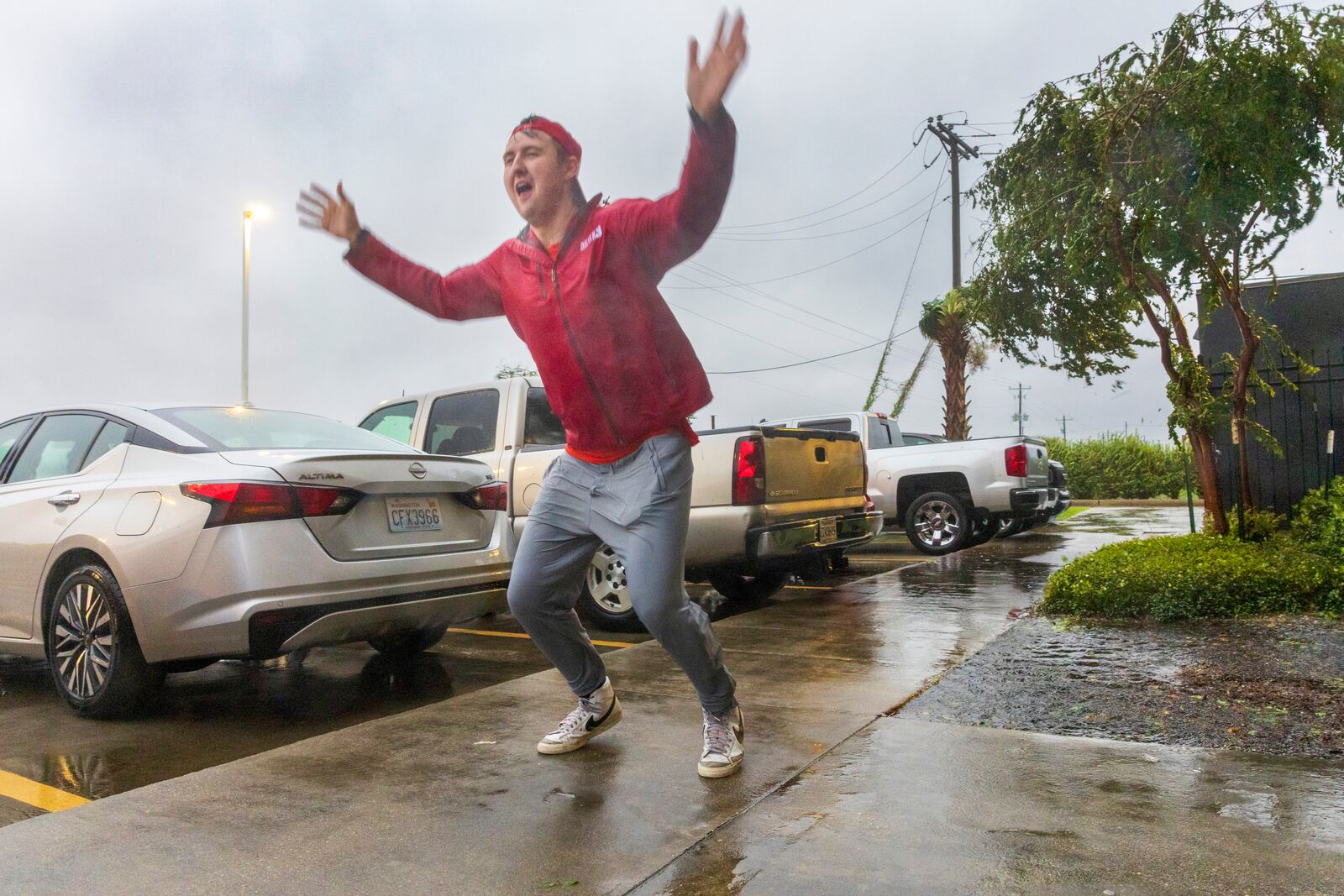 Having never before experienced the powerful forces of a hurricane, meteorologist Max Claypool of Memphis, Tenn. tries to see if the powerful winds blowing from the Hurricane Francine eye wall could lift him further in the air on Wednesday, Sept.11, 2024, Houma, La. (Chris Granger/The Times-Picayune/The New Orleans Advocate via AP)