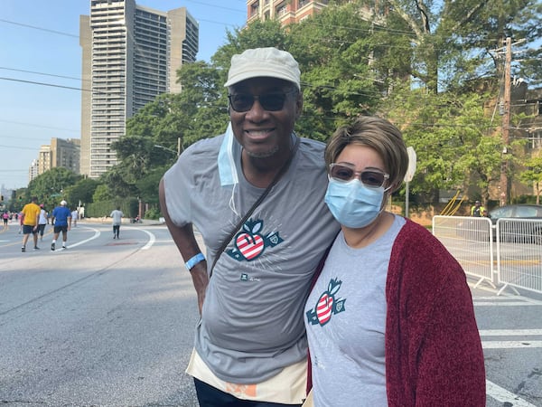 Wendy and George Harris, who live in Atlanta’s West End, have volunteered at the race for more than 15 years. (Photo: Anjali Huynh/AJC)