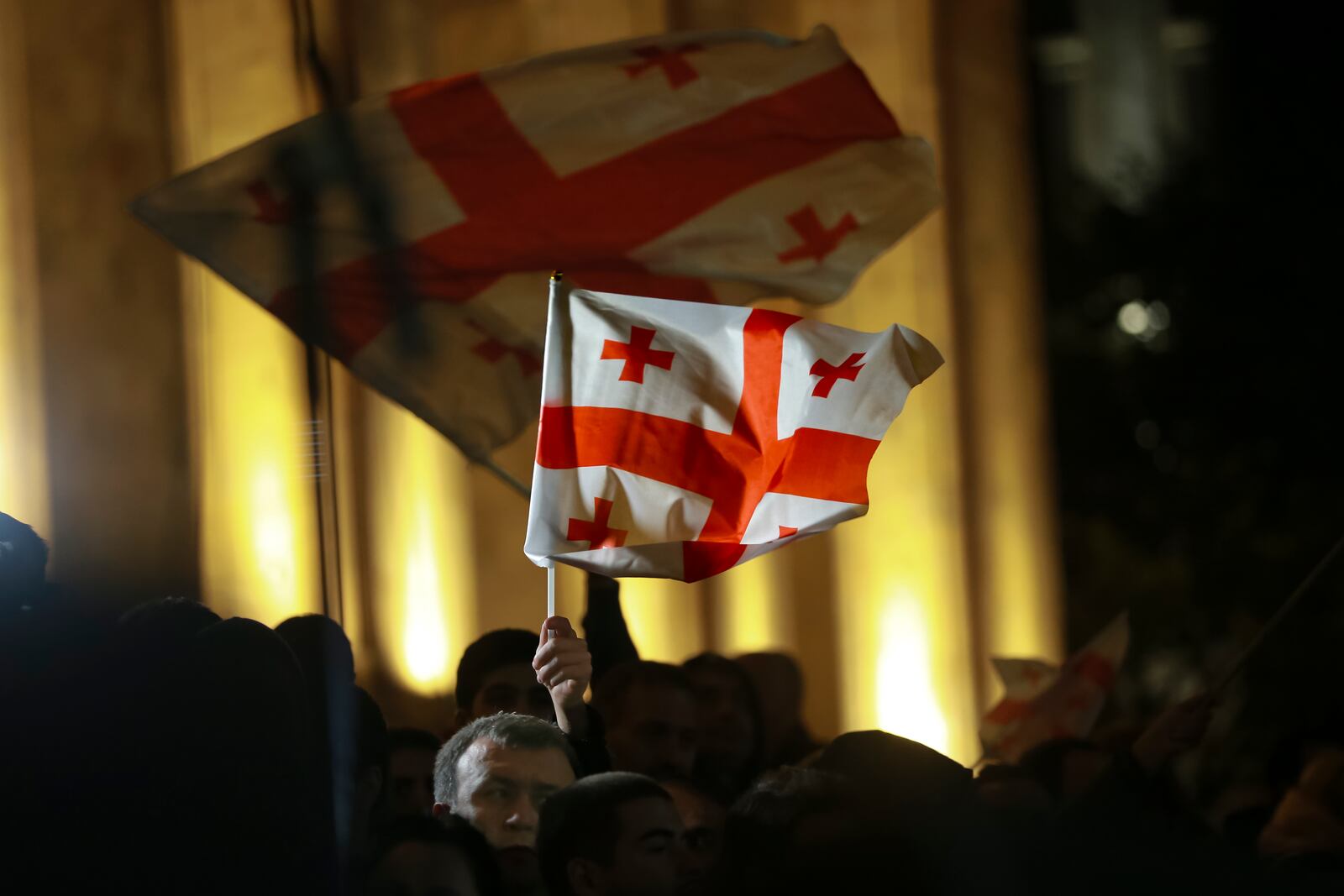 Demonstrators wave Georgian national flags during an opposition protest against the results of the parliamentary election in Tbilisi, Georgia, on Monday, Oct. 28, 2024. (AP Photo/Zurab Tsertsvadze)