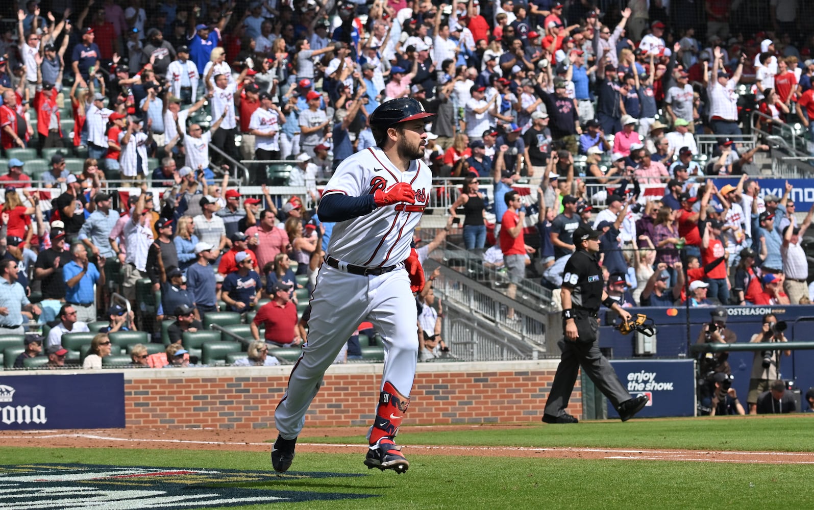 Atlanta Braves' Travis d'Arnaud hits a solo home run during the second inning of game one of the baseball playoff series between the Braves and the Phillies at Truist Park in Atlanta on Tuesday, October 11, 2022. (Hyosub Shin / Hyosub.Shin@ajc.com)