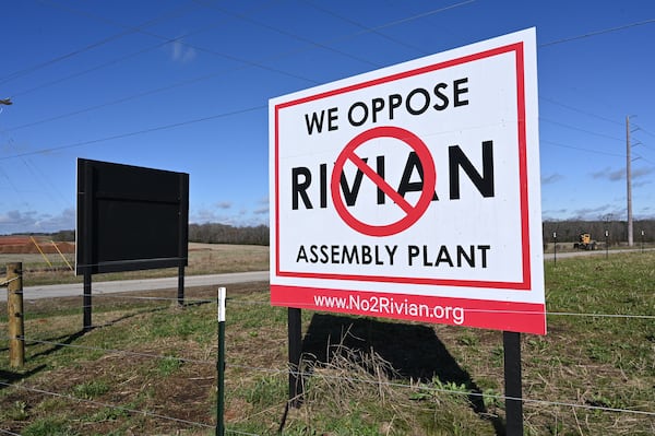 Signs to oppose the Rivian Assembly Plant are seen at Old Mill Road and Davis Academy Road near the 2,000-acre Rivian factory site in southern Walton and Morgan counties. (Hyosub Shin / Hyosub.Shin@ajc.com)