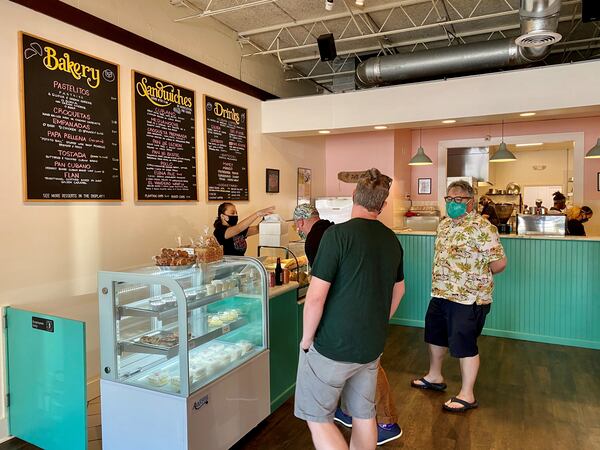 Customers ogle the pastry case at Buena Gente Cuban Bakery on Clairmont Road. Wendell Brock for The Atlanta Journal-Constitution