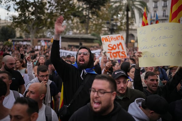 Demonstrators gather for a protest organized by social and civic groups, denouncing the handling of recent flooding under the slogan "Mazón, Resign," aimed at the president of the regional government Carlos Mazon, in Valencia, Spain, Saturday, Nov. 9, 2024. (AP Photo/Emilio Morenatti)