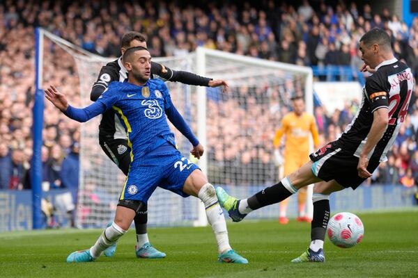 Chelsea's Hakim Ziyech, left, and Newcastle's Miguel Almiron vie for the ball during the English Premier League soccer match between Chelsea and Newcastle United at Stamford Bridge stadium in London, Sunday, March 13, 2022. (AP Photo/Kirsty Wigglesworth)