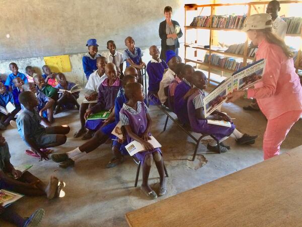 Barbara Mayfield, who started the small books project in Zimbabwe to send books and educational materials to schools and libraries in the country’s rural areas, helps teach a library class in Zimbabwe. Courtesy of Claude and Barbara Mayfield