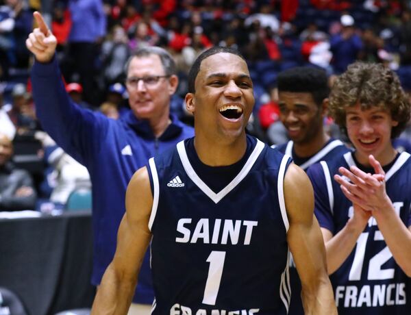 St. Francis head coach Drew Catlett (from left), guard Dwon Odom and teammates celebrate a 73-69 victory over Eagles Landing as time expires in their Class A-Private Boys state championship game on Wednesday, March 6, 2019, in Macon. Curtis Compton/ccompton@ajc.com