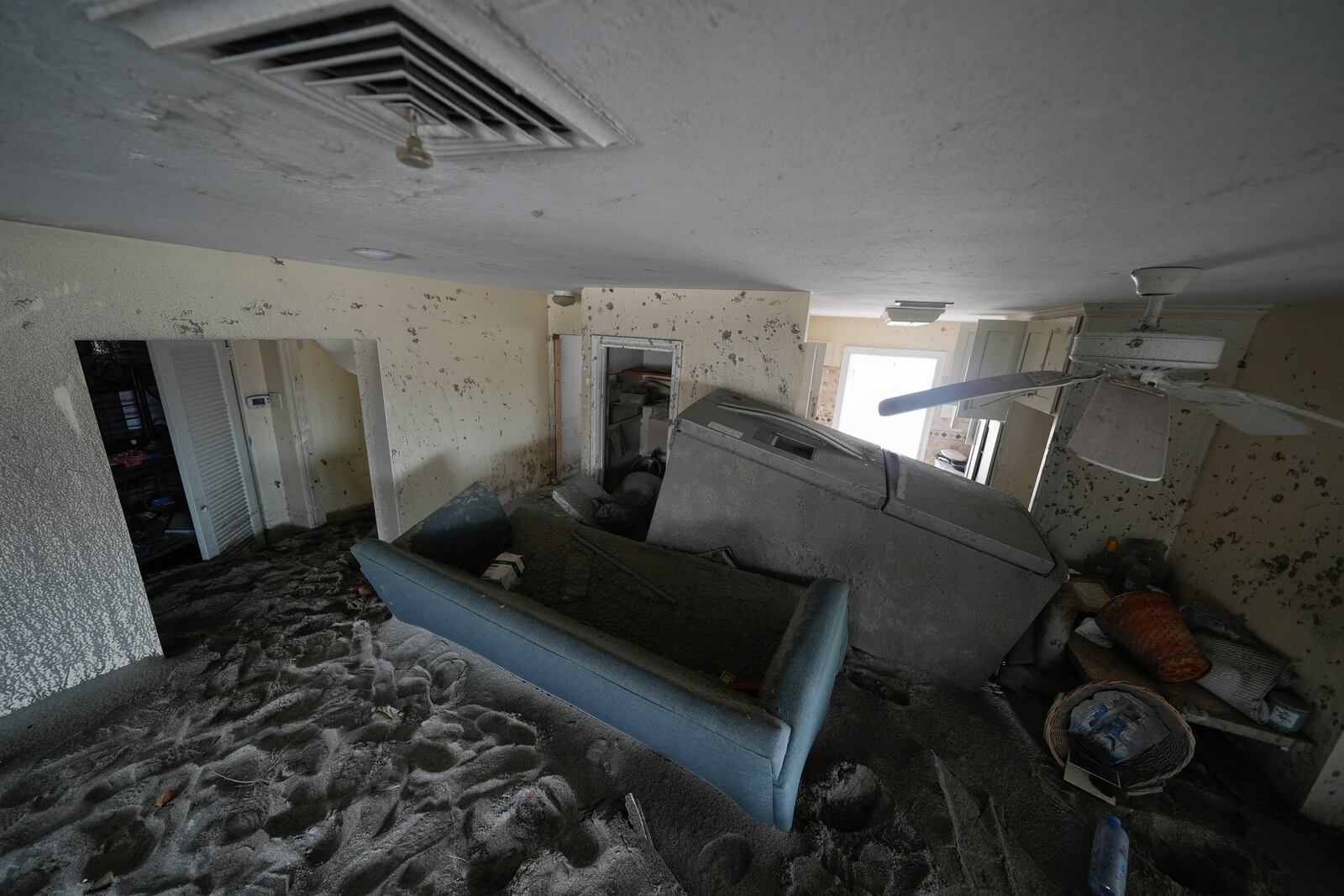 Several feet of sand fills a condo following the passage of Hurricane Milton, at YCA Vacation Rentals in Venice, Fla., Friday, Oct. 11, 2024. (AP Photo/Rebecca Blackwell)