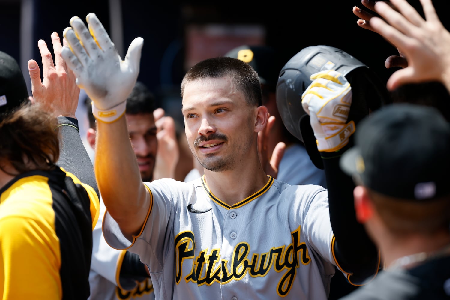 Pirates center fielder Bryan Reynolds celebrates with teammates after he hit a home run Sunday at Truist Park. (Miguel Martinez / miguel.martinezjimenez@ajc.com)