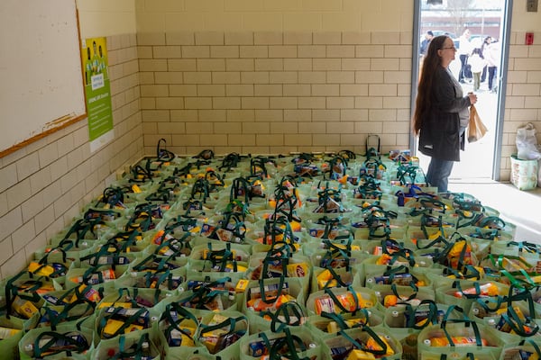 In addition to fresh produce and vegetables, attendees received a bag filled with canned goods and rice. Saturday, December 14, 2024 (Ben Hendren for the Atlanta Journal-Constitution)