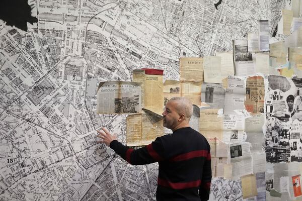 French street artist Shuck One works on a mural during the preparation of the exhibition "Paris Noir", at the Centre Pompidou Museum, in Paris, Tuesday, Feb. 18, 2025. (AP Photo/Thibault Camus)