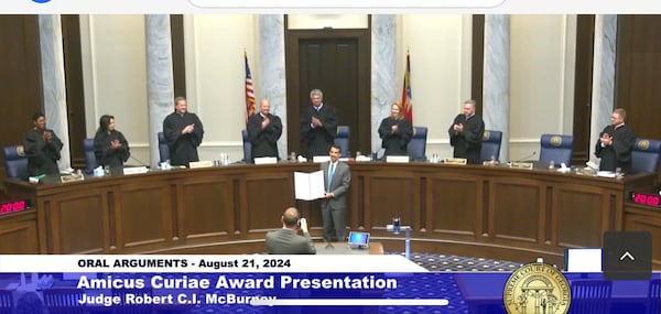 Fulton County Judge Robert McBurney receives the Amicus Curiae Award from the Georgia Supreme Court.