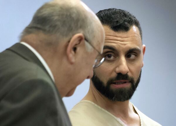 Richard Dabate, right, speaks with attorney Hubie Santos during his arraignment April 17, 2017, in Rockville Superior Court in Vernon, Conn. Dabate is charged in the fatal shooting of his wife, 39-year-old Connie Dabate, at their home on Dec. 23, 2015.