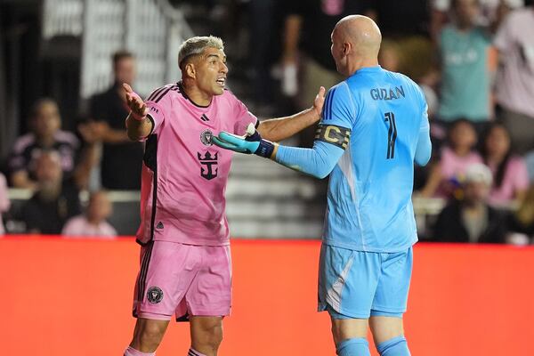 Atlanta United goalkeeper Brad Guzan (1) and Inter Miami forward Luis Suárez (9) talk on the field during the first half of an MLS playoff opening round soccer match, Saturday, Nov. 9, 2024, in Fort Lauderdale, Fla. (AP Photo/Rebecca Blackwell)