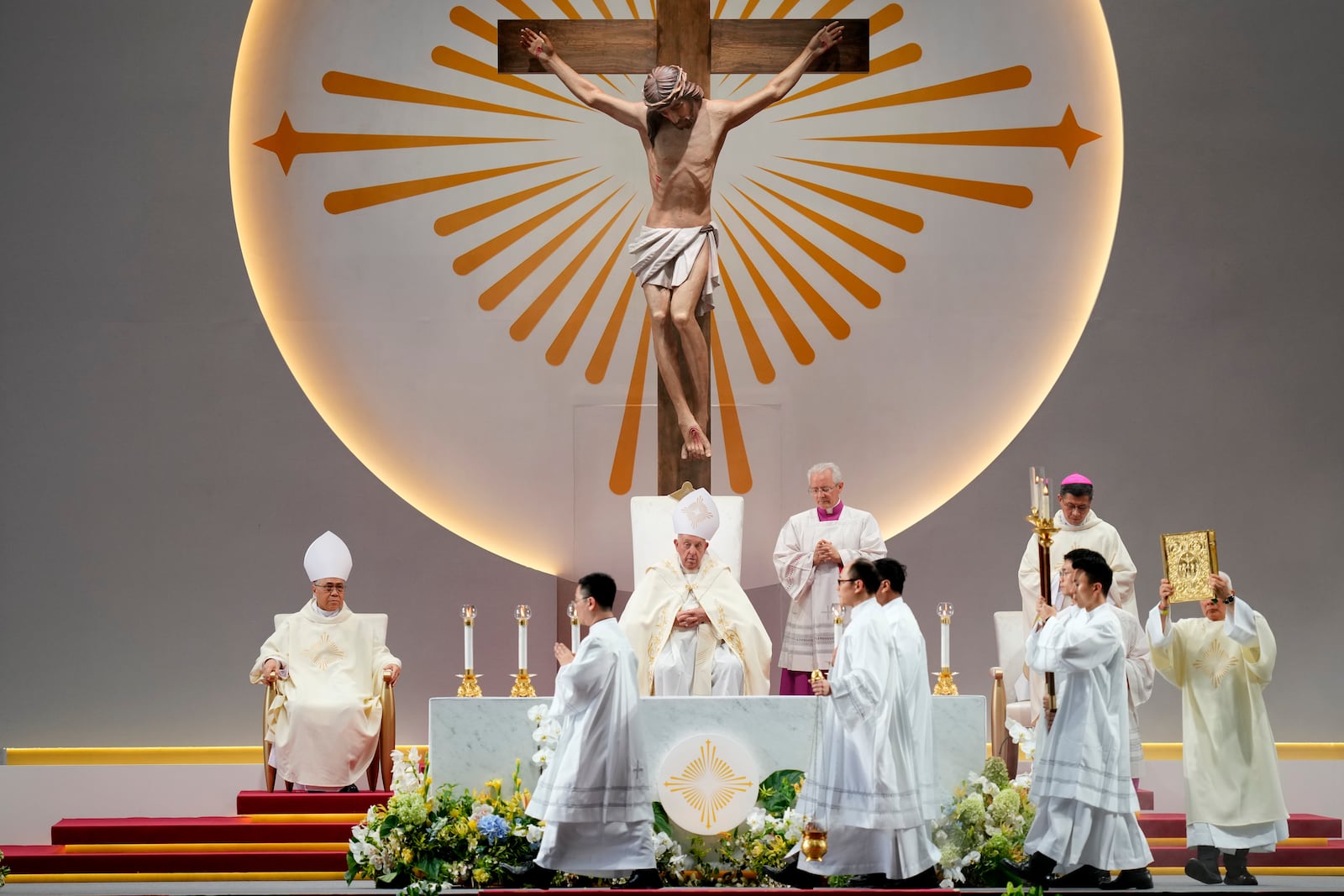 Pope Francis, seated center, presides over a holy mass at the SportsHub National Stadium in Singapore, Thursday, Sept. 12, 2024. (AP Photo/Vincent Thian)