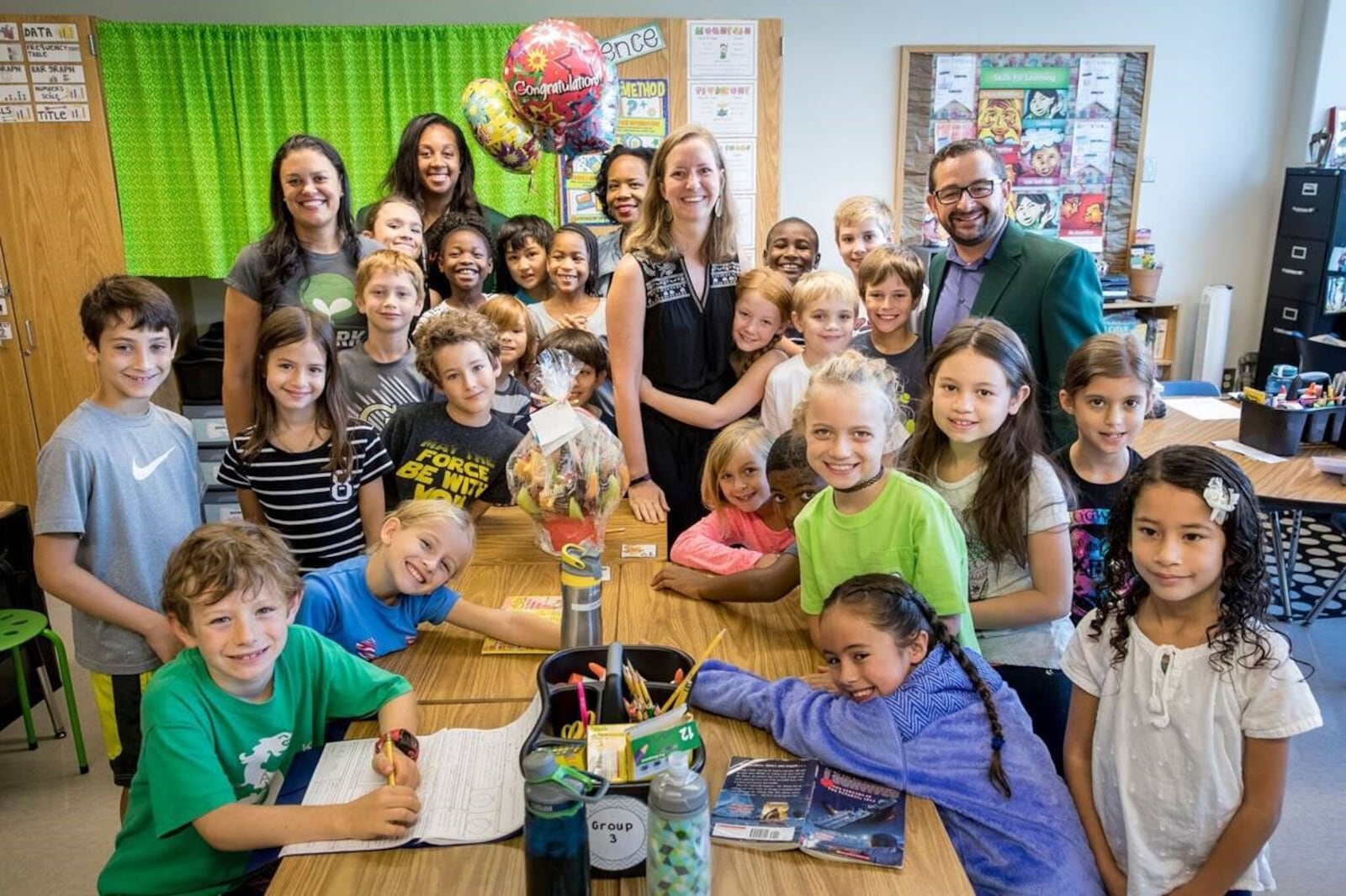 Atlanta Public Schools' Elementary School Teacher of the Year and APS Districtwide Teacher of the Year finalist Jennifer Lockwood is surrounded school and district officials and her third grade students after learning she was a finalist for the award. Photo courtesy of Ben Dashwood, Raftermen Photography