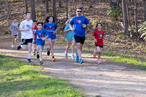 Kids with the Walton Youth Running Club work out in Marietta on Thursday, March 28, 2024.   (Ben Gray / Ben@BenGray.com)