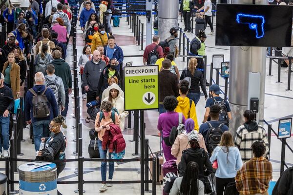 Travelers stand in line to go through the security checkpoint at Hartsfield-Jackson Atlanta International Airport during a busy Friday morning, October 28, 2022. (Steve Schaefer/steve.schaefer@ajc.com)