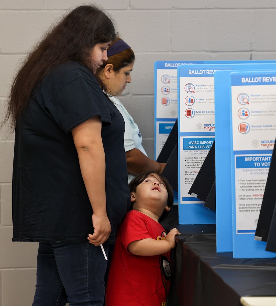 Two-year-old Adam Martinez watch his mother Carolina cast her ballot at The Nett Church at Berkmar Church in Lilburn. PHIL SKINNER FOR THE ATLANTA JOURNAL-CONSTITUTION