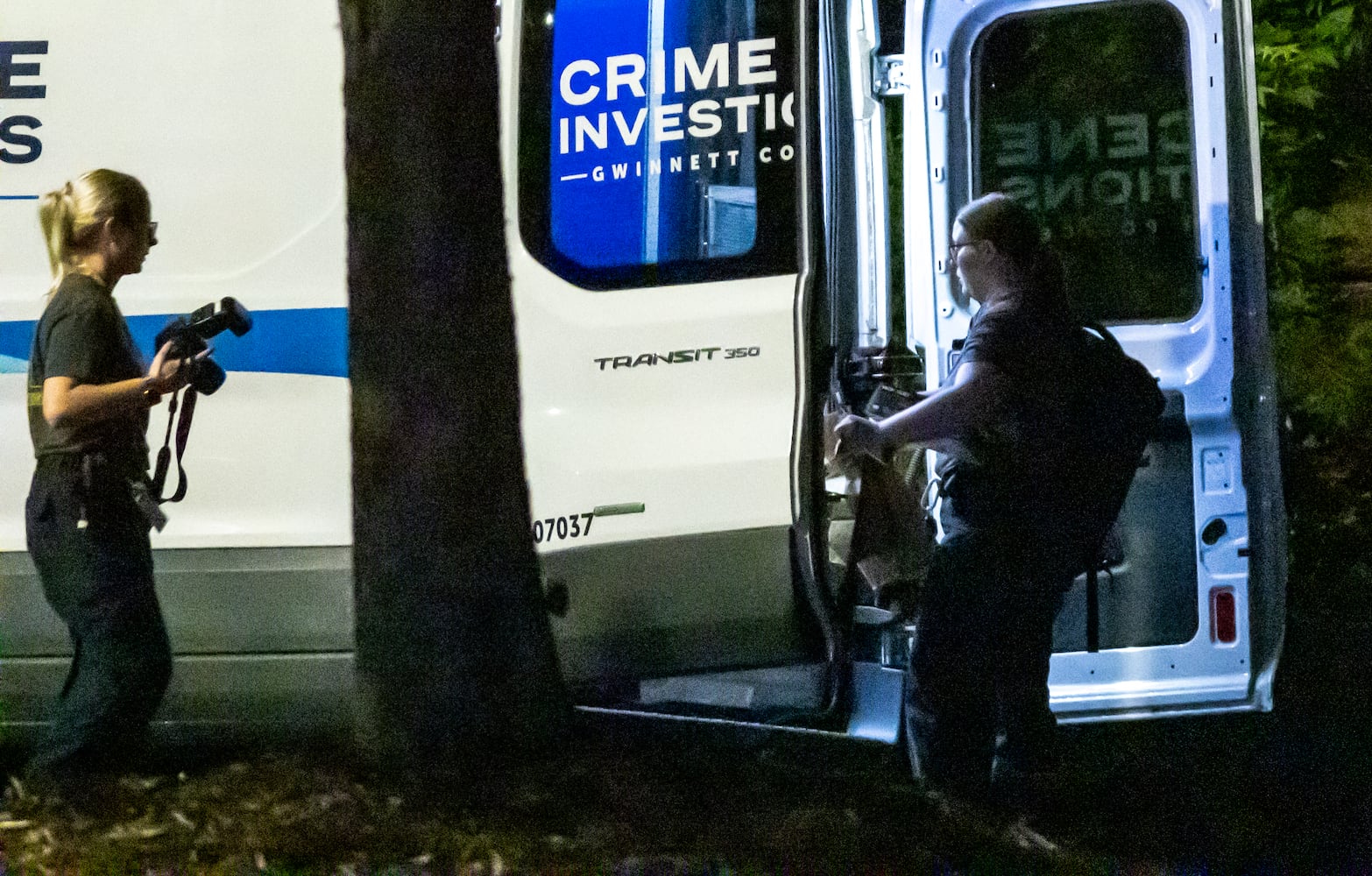 Investigators examine the scene of a shooting, where a man and three children shot to death inside a car at Lucky Shoals Park outside of Tucker on Wednesday, May 8, 2024. The man was in the driver’s seat. He, a boy and two girls all appeared to have been shot. Their names and ages were not released, but authorities said the children appeared to have been in elementary and middle school.  (John Spink/AJC)