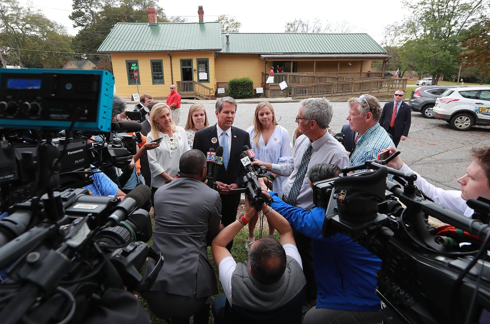 Members of the news media surround then-Secretary of State Brian Kemp, the Republican candidate for Georgia governor, after he cast his vote Nov. 6 at the Winterville Train Depot. Curtis Compton/ccompton@ajc.com