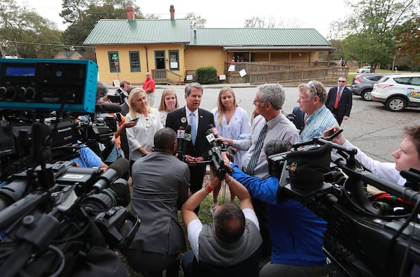 Members of the news media surround then-Secretary of State Brian Kemp, the Republican candidate for Georgia governor, after he cast his vote Nov. 6 at the Winterville Train Depot. Curtis Compton/ccompton@ajc.com