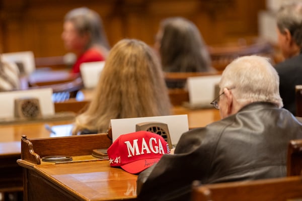 Georgia Republican elector Paul Voorhees' MAGA hat sits on a desl before electors formally cast their votes for Donald Trump and JD Vance in the Senate chambers at the state Capitol in Atlanta, Tuesday, Dec. 17, 2024. (Arvin Temkar/Atlanta Journal-Constitution via AP)