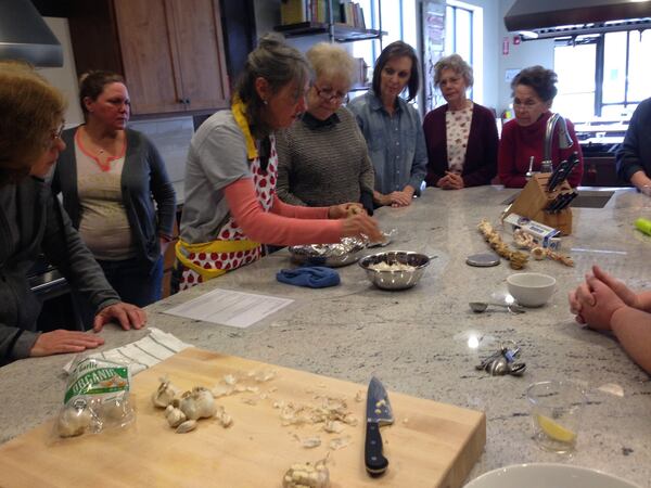 Farmer Terri Jagger Blincoe teaches students how to roast garlic at the teaching kitchen of the Rabun County regional branch of the Food Bank of Northeast Georgia. Photo credit: C. W. Cameron