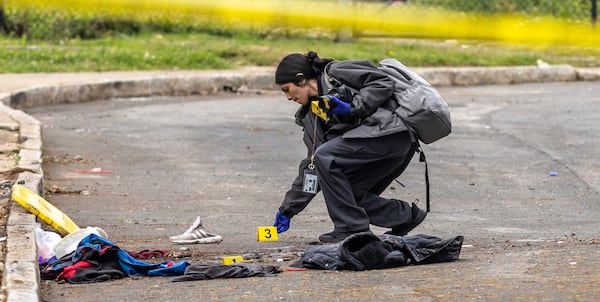 Police investigate the shooting of a woman Wednesday, April 10, 2024, on Cooper Street in southwest Atlanta. A resident who lives in the area, said he heard a gunshot and saw the woman fall about 50 feet from a homeless encampment. The resident said the woman came to the encampment every night. (Photo by John Spink/AJC)