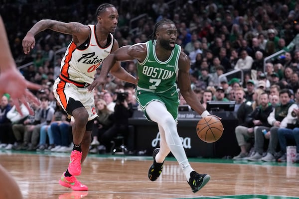 Boston Celtics guard Jaylen Brown (7) drives to the basket against Detroit Pistons forward Ronald Holland II during the first half of an NBA basketball game, Wednesday, Dec. 4, 2024, in Boston. (AP Photo/Charles Krupa)