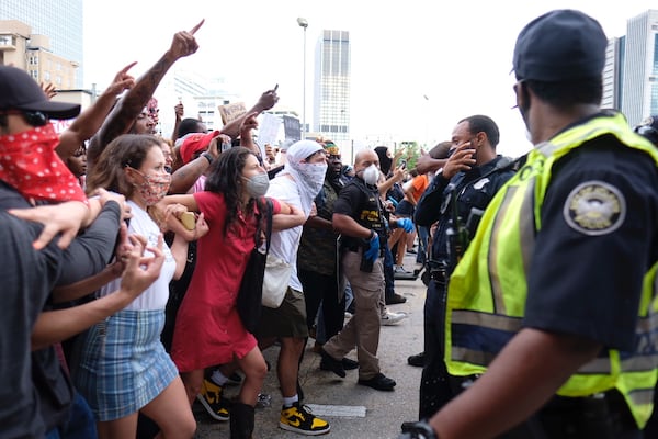 May 29, 2020 -  Atlanta -  After a peaceful march the Georgia State Capitol that swelled into the hundreds,  protestors returned to the area around the Centennial Olympic Park and CNN center where some confronted police, who sprayed some demonstrators with pepper spray.  They carried signs and chanted their messages of outrage over the death of George Floyd in Minneapolis.     