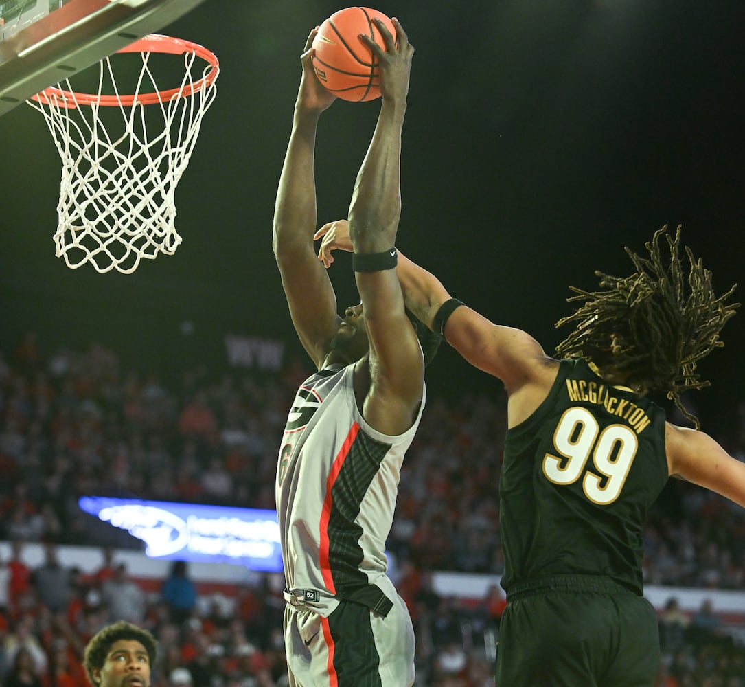 Georgia center Somto Cyril (6) is fouled by Vanderbilt forward Devin McGlockton (99) as he drives in for a dunk during the second half of an NCAA Basketball game Saturday, March 8, 2025 at Stegeman Coliseum in Athens. Georgia beat Vanderbilt 79-68. (Daniel Varnado/For the Atlanta Journal-Constitution)