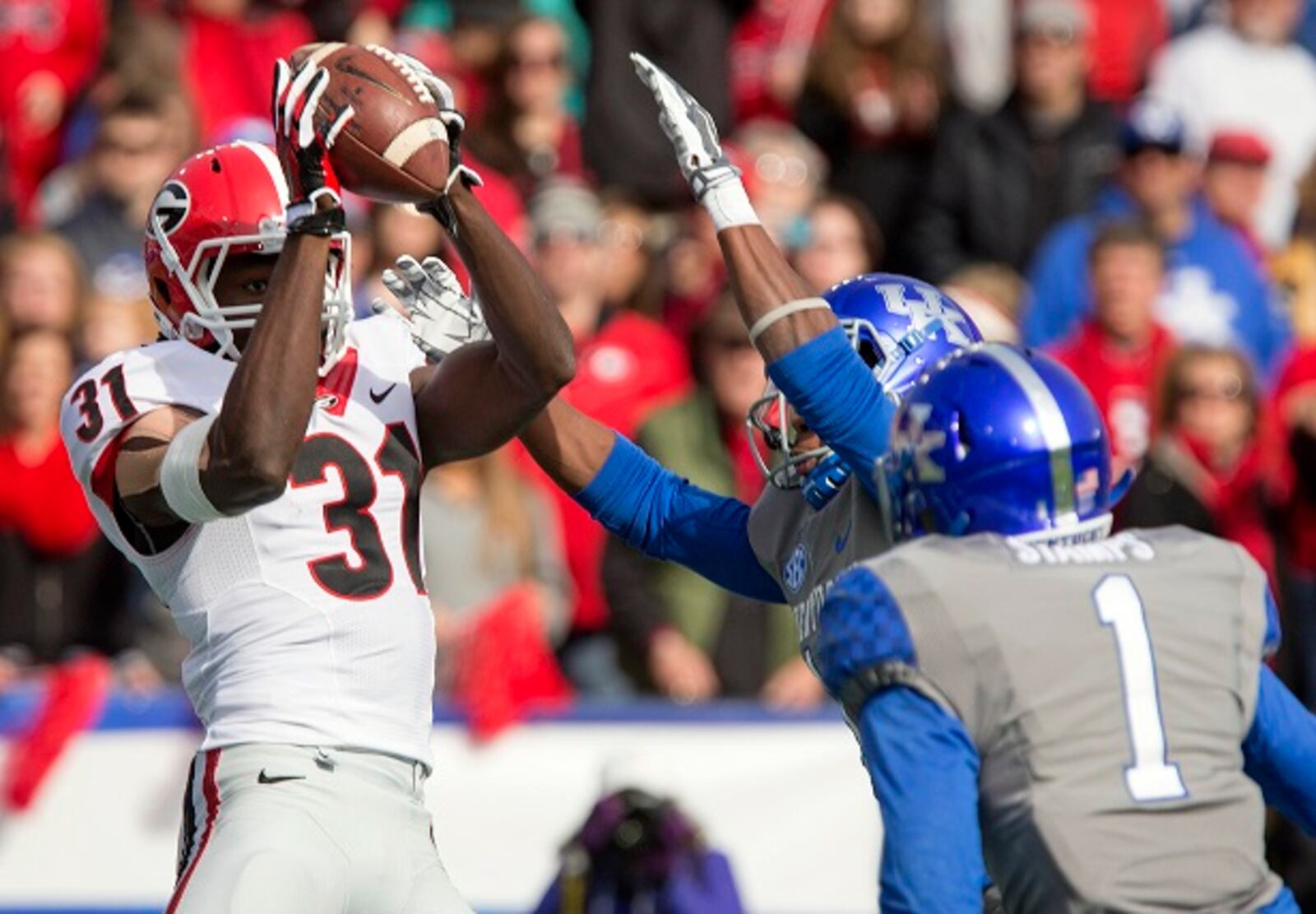 Georgia wide receiver Chris Conley, left, grabs a touchdown pass over against Kentucky during the first half of an NCAA college football game at Commonwealth Stadium in Lexington, Ky., Saturday, Nov. 8, 2014. (AP Photo/David Stephenson) Chris Conley snags one of many Georgia touchdowns. (David Stephenson/AP photo)