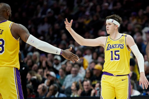 Los Angeles Lakers guard Austin Reaves reacts after making a 3-point basket against the Portland Trail Blazers during the second half of an NBA basketball game in Portland, Ore., Thursday, Feb. 20, 2025. (AP Photo/Craig Mitchelldyer)