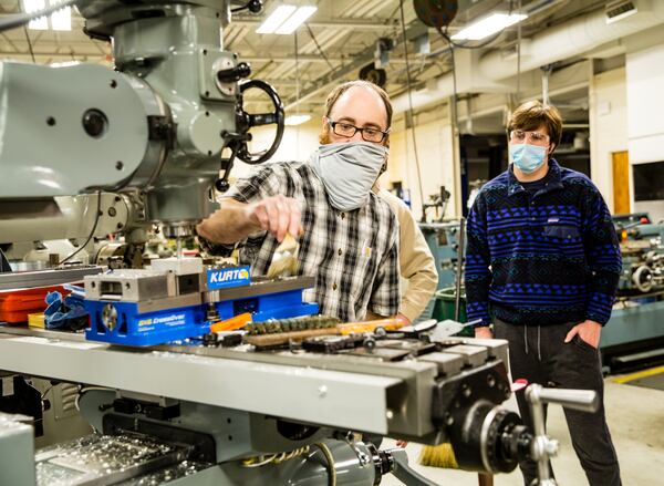 Georgia Northwestern Technical College in Rome, GA continues conducting classes, including precision machining and manufacturing labs, with smaller groups to allow for COVID-19 social distancing and with remote learning when possible Tuesday, Jan 26, 2021.  Instructor Bart Jenkins demonstrates a few basics for a class of new students including Trey Prater, right.  (Jenni Girtman for The Atlanta Journal-Constitution)