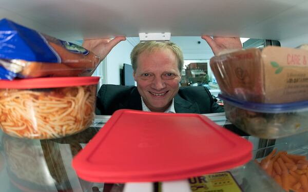 In this Tuesday, Dec. 6, 2016 photo, Brian Wansink, a food behavior scientist at Cornell University, poses for a photo in a food lab at the university in Ithaca, N.Y. Wansink says even though it shortens shelf life, move fruits and vegetables out of crisper drawers and put them at eye level. Keep good foods in clear bags or containers and less healthy things like leftover pizza in aluminum foil. In one study, people who put fruits and vegetables on the top shelf ate nearly three times more of them than they did the week before. (AP Photo/Mike Groll)