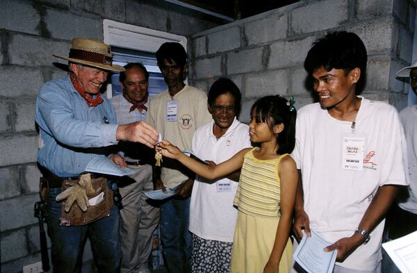 MARAGONDON, PHILIPPINES (3/26/99) --Former President Jimmy Carter gives keys to Habitat homeowner Sunshine Salas at the dedication of her family's new house. (Jimmy Carter Work Project 1999) nodownload  Â©Habitat for Humanity/Gregg Pachkowski