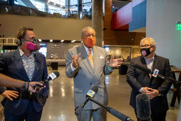 Fulton County Election Chief Richard Barron (left) and Atlanta Hawks CEO Steve Koonin (right) listen as Robb Pitts (center), Chairman of Fulton County Board of Commissioners, speaks about his optimism of having State Farm Arena host Fulton County elections during a tour of the arena in Atlanta, Friday, July 17, 2020. State Farm Arena, home of the Atlanta Hawks, will host early voting and the 2020 presidential election for Fulton County registered voters.  (ALYSSA POINTER / ALYSSA.POINTER@AJC.COM)